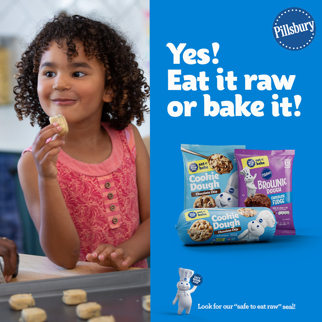 Young girl eating raw cookie dough